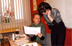 teacher hands over certificate to student